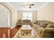 Inviting living room featuring hardwood floors, neutral walls, and comfortable seating at 3460 Drayton Manor Run, Lawrenceville, GA 30046