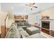Open concept living room featuring hardwood floors, a fireplace, and a staircase to the upper level at 3460 Drayton Manor Run, Lawrenceville, GA 30046