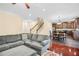 Open-concept living room with modern hardwood floors, a large sofa, and an open staircase at 3460 Drayton Manor Run, Lawrenceville, GA 30046