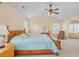 Spacious main bedroom with natural light, ceiling fan, double bed, and an archway leading to a sitting area at 3460 Drayton Manor Run, Lawrenceville, GA 30046