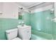 Bathroom featuring green ceramic tile, a tub, a sink with vanity, and a toilet at 4282 Roswell Ne Rd # K3, Atlanta, GA 30342