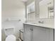 Bathroom featuring tiled walls, vanity, and toilet with white finishes at 4282 Roswell Ne Rd # K3, Atlanta, GA 30342