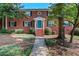 Charming brick home featuring a well-manicured lawn, colorful teal door and a welcoming facade at 4282 Roswell Ne Rd # K3, Atlanta, GA 30342