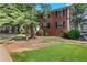 Brick apartment building with well-manicured landscaping and mature shade trees at 4282 Roswell Ne Rd # K3, Atlanta, GA 30342