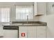 Kitchen featuring granite countertops, stainless steel appliances, white cabinetry, and modern flooring at 4282 Roswell Ne Rd # K3, Atlanta, GA 30342