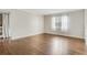 Bright room with hardwood floors, trim and baseboards, and white walls, as well as a curtained window at 4282 Roswell Ne Rd # K3, Atlanta, GA 30342