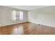 Bright living room featuring hardwood floors, neutral walls and a sunlit window with sheer white curtains at 4282 Roswell Ne Rd # K3, Atlanta, GA 30342