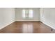 Bright room featuring hardwood floors, neutral walls, a window with blinds and sheer white curtains at 4282 Roswell Ne Rd # K3, Atlanta, GA 30342