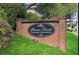 Entrance sign for Paces Forest Courtyard Condominiums set in brick and greenery at 4282 Roswell Ne Rd # K3, Atlanta, GA 30342