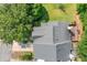 Aerial view of the property showing the roof, back deck, and surrounding trees and landscaping at 884 Edgewater Cir, Marietta, GA 30062