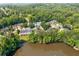 Aerial view of a community of homes by a lake with mature trees and landscape at 884 Edgewater Cir, Marietta, GA 30062