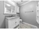 Bright bathroom featuring a white vanity with granite countertop and neutral-toned walls and flooring at 884 Edgewater Cir, Marietta, GA 30062