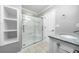 Bathroom featuring a glass shower with built-in shelves and granite vanity at 884 Edgewater Cir, Marietta, GA 30062