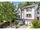 Well-maintained townhouse showcasing neutral siding, dark wood shutters, and an attached garage with brick accents at 884 Edgewater Cir, Marietta, GA 30062