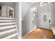 Welcoming foyer with wood floors, a staircase, and a white front door with decorative window at 884 Edgewater Cir, Marietta, GA 30062
