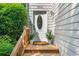 Inviting front entrance with a decorative glass door, flanked by potted plants, and a charming wooden porch at 884 Edgewater Cir, Marietta, GA 30062