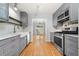 Modern kitchen with gray cabinetry, stainless steel appliances, hardwood floors, and backyard views at 884 Edgewater Cir, Marietta, GA 30062