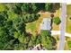 Aerial view of a home with a spacious, well-maintained lawn, surrounded by mature trees at 1120 Bagwell Dr, Kennesaw, GA 30152