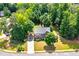 Aerial view of a traditional brick home surrounded by lush, mature trees and landscaping at 1120 Bagwell Dr, Kennesaw, GA 30152
