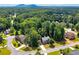Aerial view of a traditional home surrounded by lush greenery, mature trees and mountain views at 1120 Bagwell Dr, Kennesaw, GA 30152