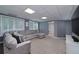 Finished basement featuring carpet, gray walls, a large couch, and natural light from the windows at 1120 Bagwell Dr, Kennesaw, GA 30152