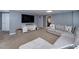 Finished basement featuring gray walls, carpet, a large television, and a comfortable couch at 1120 Bagwell Dr, Kennesaw, GA 30152