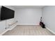 Finished basement featuring gray walls, carpet, large television, and guitar at 1120 Bagwell Dr, Kennesaw, GA 30152
