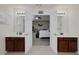 Double doors open to main bedroom from bathroom with separate vanities and mirrors and coordinated lighting fixtures at 1120 Bagwell Dr, Kennesaw, GA 30152