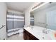 Bathroom featuring a double sink vanity, toilet, shower with a gray and white striped curtain at 1120 Bagwell Dr, Kennesaw, GA 30152