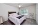 Comfortable bedroom with ceiling fan, plush carpet, and natural light from the large window creates a cozy retreat at 1120 Bagwell Dr, Kennesaw, GA 30152