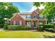 Charming red brick two-story house with blue shutters and a covered front porch at 1120 Bagwell Dr, Kennesaw, GA 30152