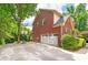 Traditional brick home exterior featuring an attached two-car garage and a basketball hoop at 1120 Bagwell Dr, Kennesaw, GA 30152