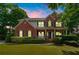 Charming two-story brick home with manicured landscaping and welcoming front porch at 1120 Bagwell Dr, Kennesaw, GA 30152