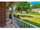 Charming front porch with white railings and a view of the landscaped front yard and street at 1120 Bagwell Dr, Kennesaw, GA 30152