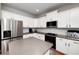 Bright kitchen with white cabinets, stainless steel appliances, and a gray granite island at 1120 Bagwell Dr, Kennesaw, GA 30152
