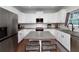 Modern kitchen featuring white cabinetry, granite countertops, and stainless steel appliances at 1120 Bagwell Dr, Kennesaw, GA 30152