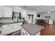 Eat-in kitchen with stainless appliances, island and backyard access, flowing into an open floor plan at 1120 Bagwell Dr, Kennesaw, GA 30152