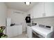 Bright laundry room with washer, dryer, cabinets, sink, and laundry themed wall decor at 1120 Bagwell Dr, Kennesaw, GA 30152