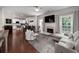 Spacious open-concept living room with fireplace, hardwood floors, and modern decor flowing into a kitchen at 1120 Bagwell Dr, Kennesaw, GA 30152