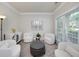 Cozy sitting room with neutral walls, plush seating, and ample natural light from a large window at 1120 Bagwell Dr, Kennesaw, GA 30152