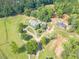 Aerial view of a beautiful property with a long driveway, garden, outbuilding, and manicured lawn at 2229 S Van Wert S Rd, Villa Rica, GA 30180