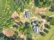 Aerial shot of the property showcasing a large house, outbuilding, pond, and gardens at 2229 S Van Wert S Rd, Villa Rica, GA 30180