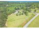 Lush property with a home and barn surrounded by mature trees and large grassy fields at 2229 S Van Wert S Rd, Villa Rica, GA 30180