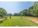 Expansive backyard with mature trees, a swing set, and a sprawling lawn at 2229 S Van Wert S Rd, Villa Rica, GA 30180