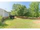 Expansive backyard featuring lush green lawn and mature trees with a trailer parked beside the home at 2229 S Van Wert S Rd, Villa Rica, GA 30180