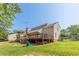 Spacious backyard with a wooden deck, lower level storage, and lush green grass at 2229 S Van Wert S Rd, Villa Rica, GA 30180