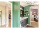 Open bathroom with a gray vanity and green walls with a glimpse of another bathroom at 2229 S Van Wert S Rd, Villa Rica, GA 30180