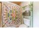 Bathroom with a colorful shower curtain, stacked towels, and a white toilet at 2229 S Van Wert S Rd, Villa Rica, GA 30180