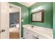 Bathroom with green walls, a white vanity, and a view into a bedroom at 2229 S Van Wert S Rd, Villa Rica, GA 30180