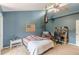 Cozy bedroom with dark blue accent wall, American flag, and unique ceiling fan at 2229 S Van Wert S Rd, Villa Rica, GA 30180
